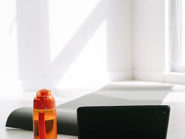 Yoga mat, water bottle, and small towel neatly arranged on the floor.